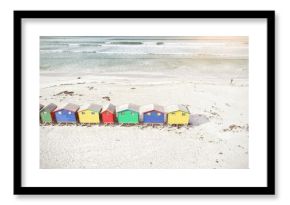 Multi colored wooden huts by mountain at beach