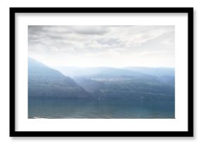 Scenic view of river by mountain against sky
