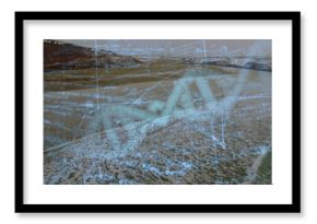 Displaying translucent DNA helix blending with sandy waves at shoreline, with floating numeric text