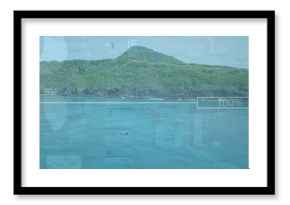 Displaying forested volcanic hill rising above tropical coastline, with digital interface overlays