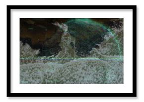 Merging blue circular overlay intersecting rocky shoreline, with waveform, data labels and sea foam