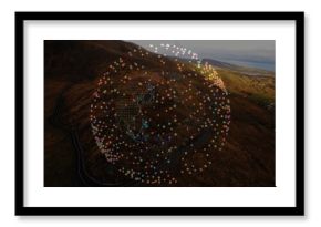 Hovering data globe floating above hillside and distant water, with winding road and neon outlines