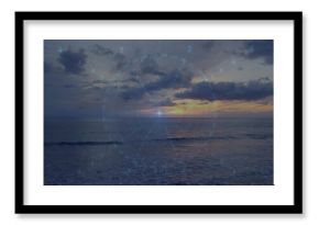 Glowing sun with centered HUD overlay reflecting on ocean at sunset, showing right coastline