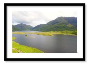 Dominating upland valley, large freshwater lake holding grassy islet, curving shoreline and path