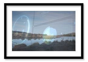 Displaying shallow pond and grassy banks reflecting dead tree at remote marsh, with HUD overlay