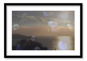 Bathing centered sun casting vertical reflection over calm sea near dark headland, with HUD charts