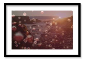 Sunset over rocky coastline with floating virus particles in foreground