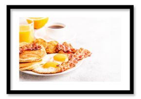 Healthy Full American Breakfast with Eggs Bacon Pancakes and Latkes.