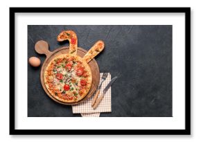 Tasty Easter pizza with bunny ears, egg and cutlery on black background