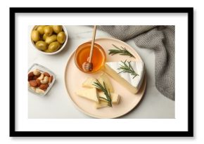 Tasty Camembert cheese with rosemary and honey on white table, flat lay