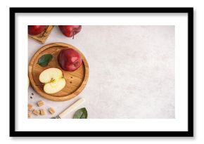 Wooden plate with fresh red apples on white background
