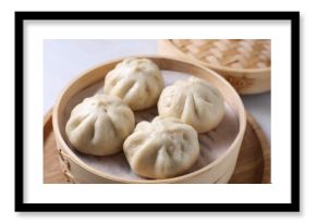 Delicious bao buns (baozi) on light table, closeup