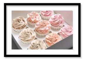 Many tasty cupcakes with colorful cream in box, closeup