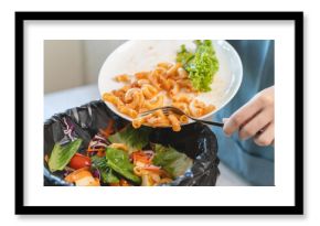Compost from leftover food in the meal in household, female hand holding left over meal use fork scraping waste, rotten vegetable throwing away into garbage, trash or bin. Environmentally responsible