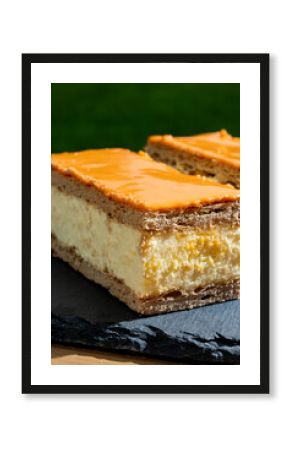 Celebration of the King birthday in Netherlands, tompoes or tompouce, iconic pastry in Netherlands made from puff dough, orange icing, cream