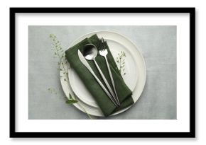Stylish setting with cutlery, leaves and plates on grey table, top view