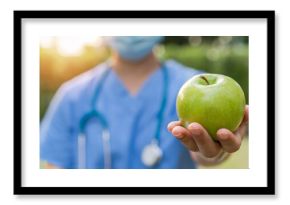 World health day, National nutrition week,an apple a day keeps the doctor away concept by eating high nutritious clean food and healthy nutritional diet with doctor handling green apple to patient