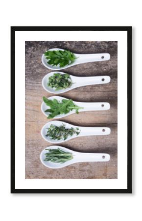 assortment of  herbs in ceramic spoon