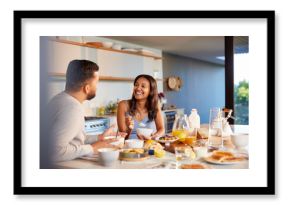 Multiethnic couple enjoying breakfast at home