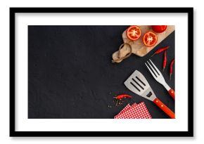 Picnic flatlay. Steel barbecue utensils with tomatoes and greens, top view