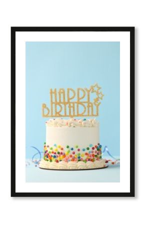 Delicious bento cake with colorful sprinkles, topper and serpentine streamer on white table