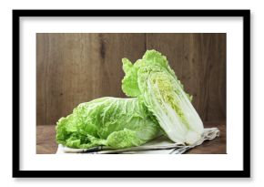 Whole and cut Chinese cabbages on wooden table