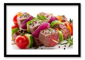 Juicy pieces of beef are skewered with vibrant vegetables including bell peppers, onions, and cherry tomatoes, showcasing flavors perfect for a summer barbecue