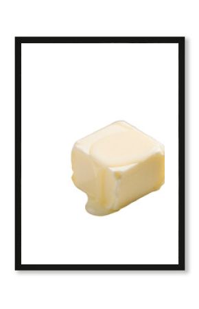 Small cube of pale yellow butter with melting corner pooling softly