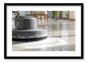 The professional floor scrubber performing a deep clean on shiny tiles.