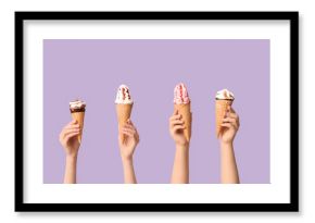 Female hands with different sweet ice-cream in waffle cones on lilac background