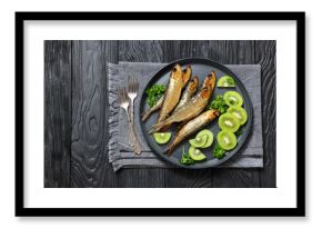 Hot smoked Baltic herrings with kiwi fruit slices