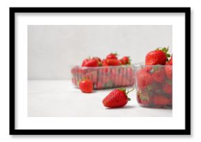 Plastic containers with fresh strawberry on light background, closeup