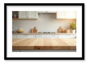 Empty wood table top in modern kitchen interior. Ready for product montage food presentation. Blurred clean bright background with white cabinets, decor, utensils, green plant in daylight. Wooden