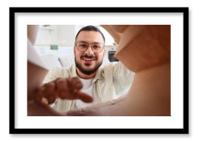 Young man with paper bag at home, view from inside. Food delivery service