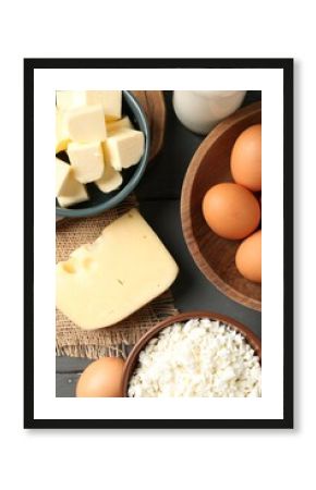 Different dairy products and eggs on grey wooden table, flat lay