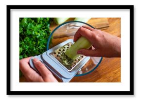 Woman grating fresh cucumber, close-up 