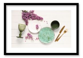 Beautiful table setting with lilac flowers on white wooden background