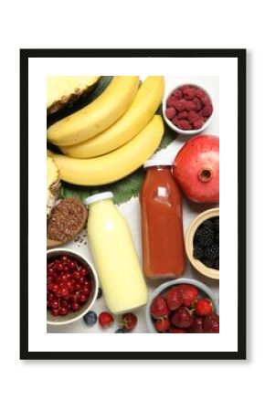 Superfood. Bottles with tasty smoothies and ingredients on light wooden table, flat lay