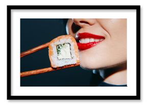 Bright and vivid close-up of a woman's smile with red lipstick, holding sushi with chopsticks, showcasing Asian cuisine and delightful emotions.