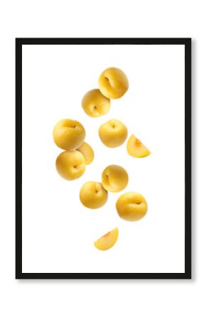 Fresh ripe cherry plums falling on white background