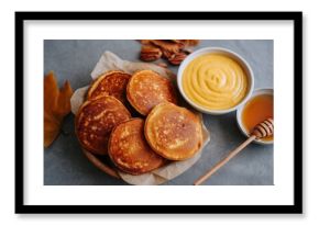 Mini Pancakes with Pumpkin Puree, Pecans, and Maple Syrup on Stone Background