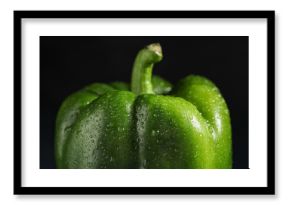 Green bell pepper on black background, closeup