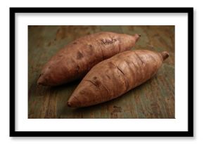 Sweet potatoes roasted in the oven on rustic wooden surface