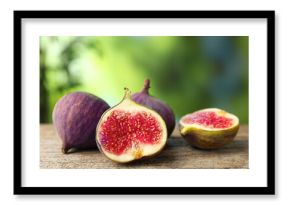 Fresh ripe figs on wooden table outdoors, closeup