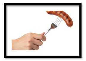 a hand holding a sausage on a fork for a meal