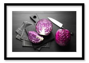 Fresh red cabbages and knife on black wooden table, flat lay