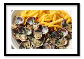 Steamed Clams with herbs and French fries in a white plate