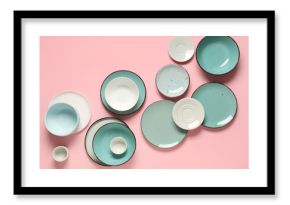 Set of clean plates and bowls on pink background