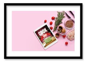 Digital recipe book and different ingredients on pink background