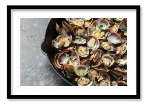 Steamed Clams with garlic, parsley and white wine in a cast iron pan